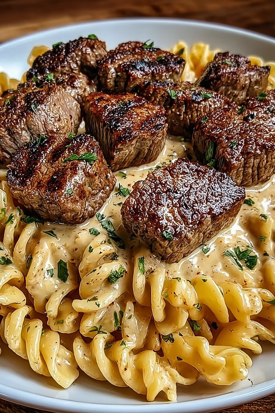 Creamy Garlic Butter Steak Bites with Spicy Cajun Alfredo Twisted Pasta extra recipe photo